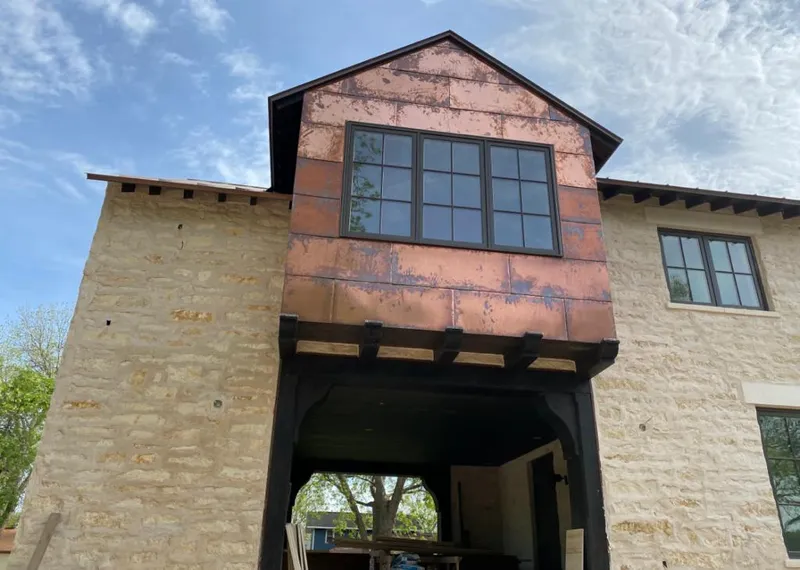 Copper metal panel facade on a stone building for Metal Roof Coating in Commerce City